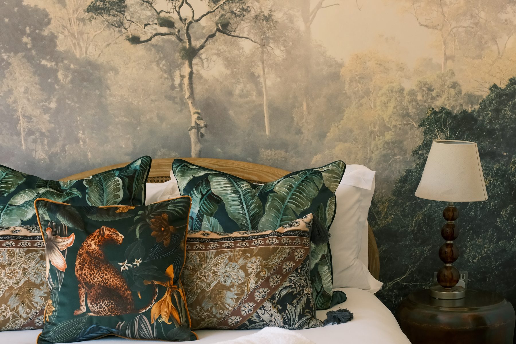 The bedroom at The Frogs, with a leopard-print cushion on the bed