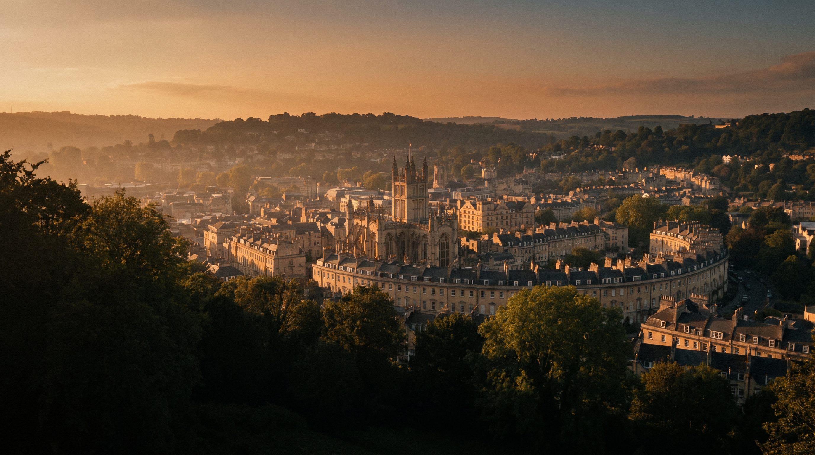 Bath's Georgian crescents from above in warm evening light